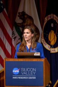 Lara Lash '13 behind a podium delivering a presentation at NASA Ames Research Center