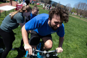 A student powers a bike during Earthfest 