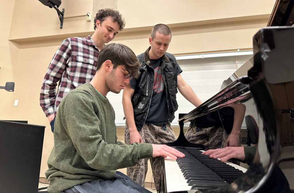 Daniel Ruggiero ’25, Owen York ’26, and Conrad Tilroe Jr. ’25 prepare for World Piano Day.