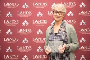Carla Odell, with Creative Minds at Northampton County Prison holds an award at the Landis 2024 awards ceremony.