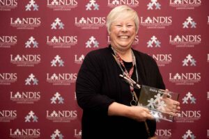 Elaine Reynolds holds an award at the Landis 2024 awards ceremony.