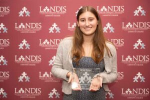 Emily Kogut '24 holds an award at the Landis 2024 awards ceremony.