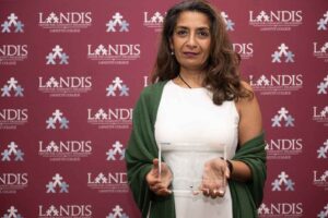 Nandini Sikand holds an award at the Landis 2024 awards ceremony.
