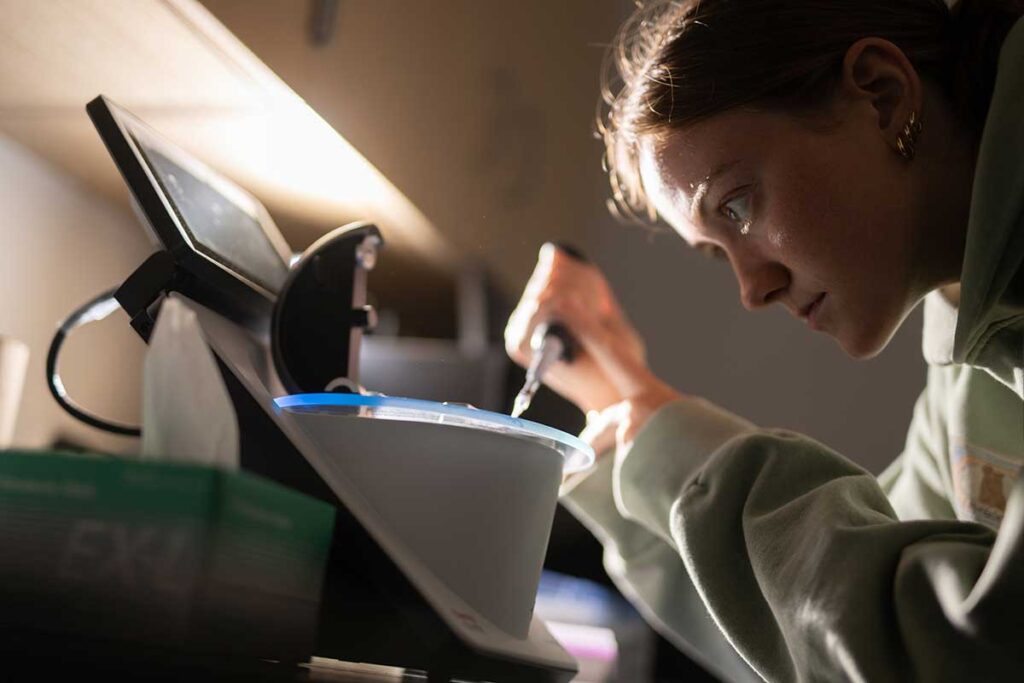 Lafayette student Sophia Guitar conducting genetic research in a biology lab