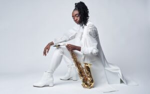 Lakecia Benjamin is shown with a saxophone