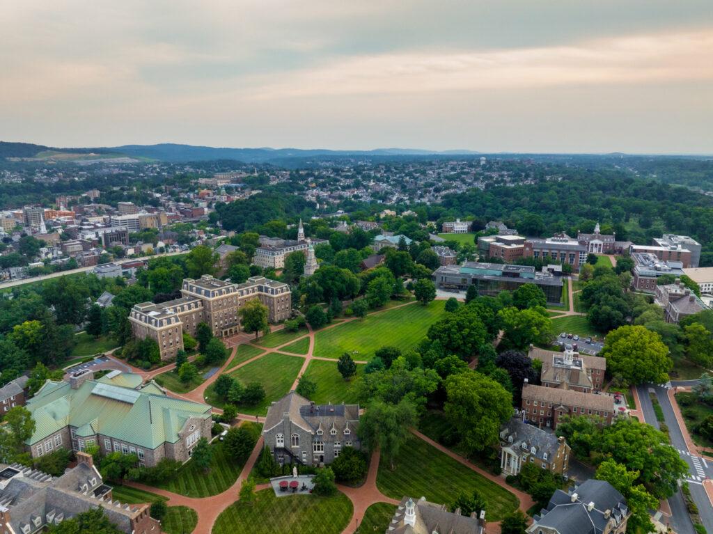 An aerial view of Lafayette college's quad. The top 25% of the frame is and early evening sky. The city of Easton Pa and it's West Ward can be seen in the background.