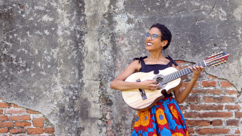 Fabiola Méndez smiles with an instrument.