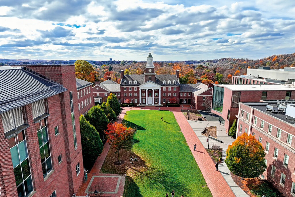 Aerial photo of Watson Hall in front of fall foliage.