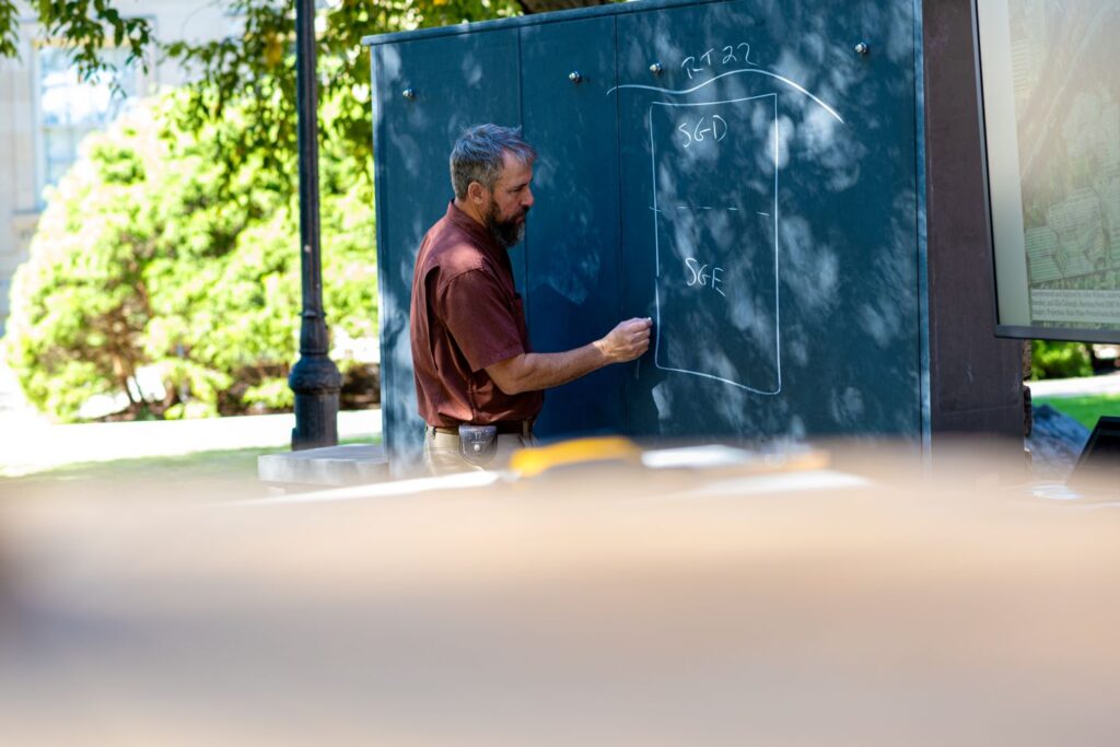 John Wilson, laboratory coordinator, at the chalkboard made from locally quarried slate. | Photo by Adam Atkinson