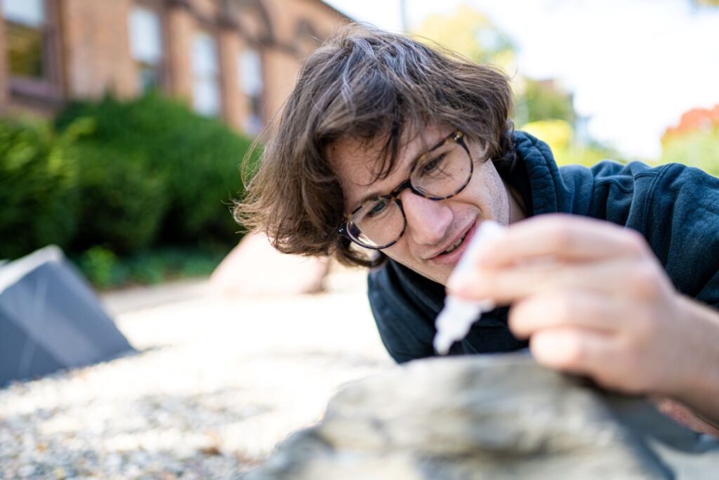 Jack Holinstat '27 tests for the presence of calcite in the rock garden samples. | Photo by Adam Atkinson