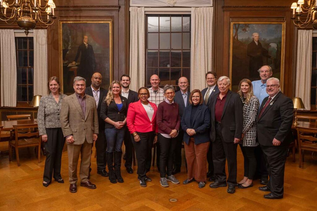 Members of the Pennsylvania House of Representatives’ Tourism and Economic and Recreational Development Committee are standing in Kirby Library. Two Lafayette professors join the group - Bruce Murphy (far right back row) and John Kincaid (front row third from right). Staff members Mary Wilford-Hunt (far left) and Maurice Luker (far right) also join the group.