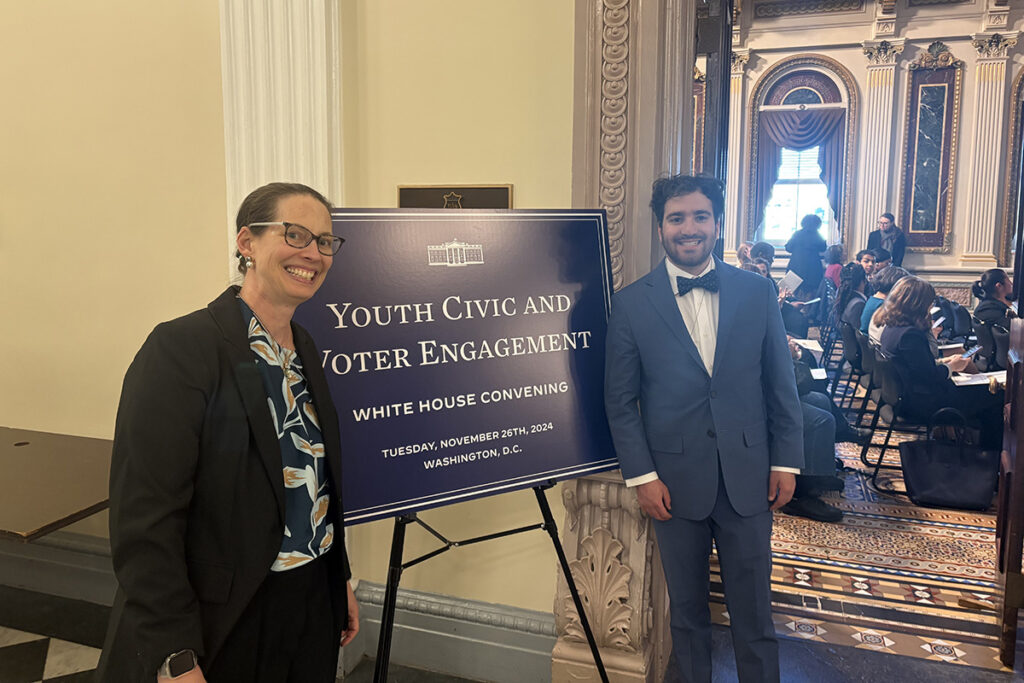 Prof. Caroline Lee and Chris Byrnes ’26 stand with a sign that reads Youth Civic and Voter Engagement