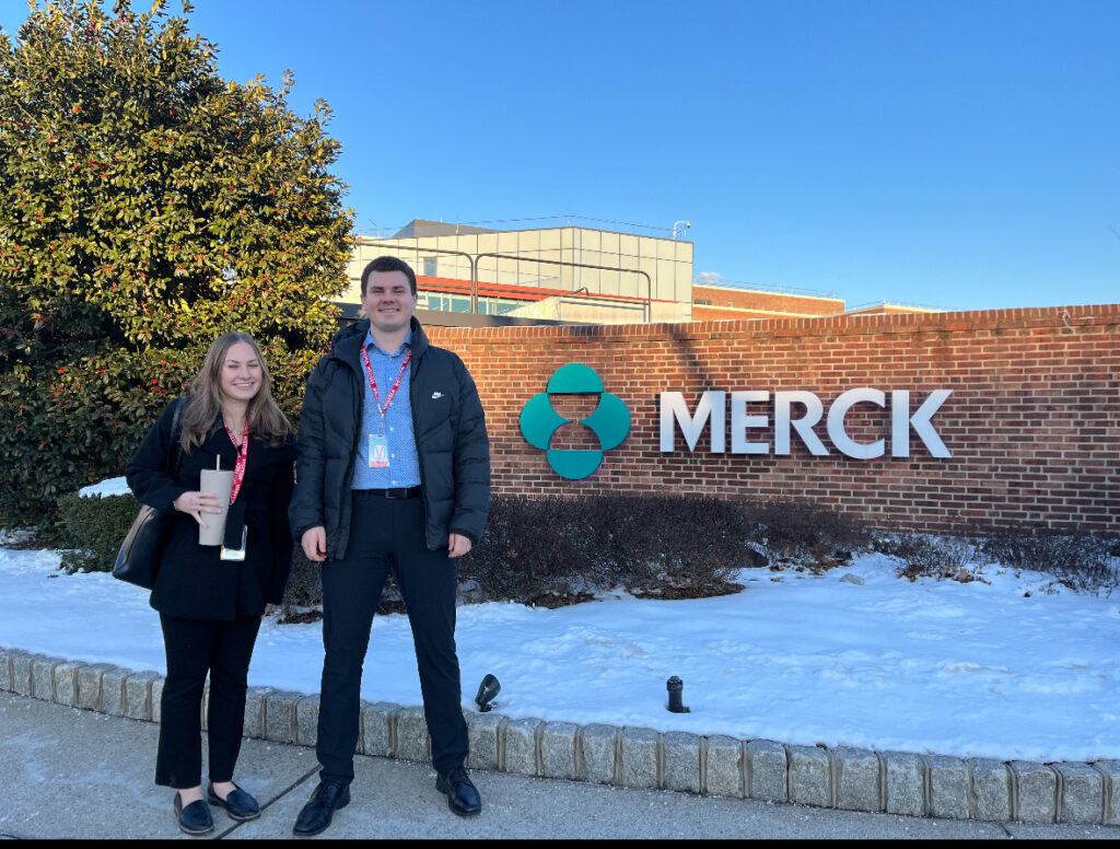 Students outside of a MERCK sign during their externship experience 