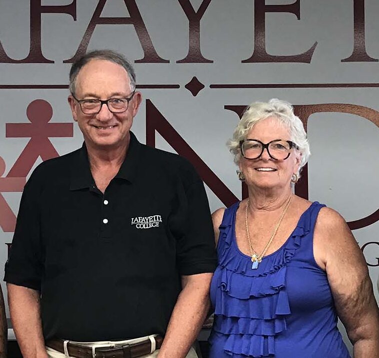 Tom '67 and Sharon Smith are standing and smiling at the camera.