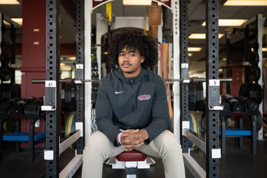 Saiku White '25 is seated in the weight room.