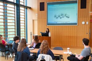 Olivia Naum '26 giving her final presentation during the Global Stimulants course