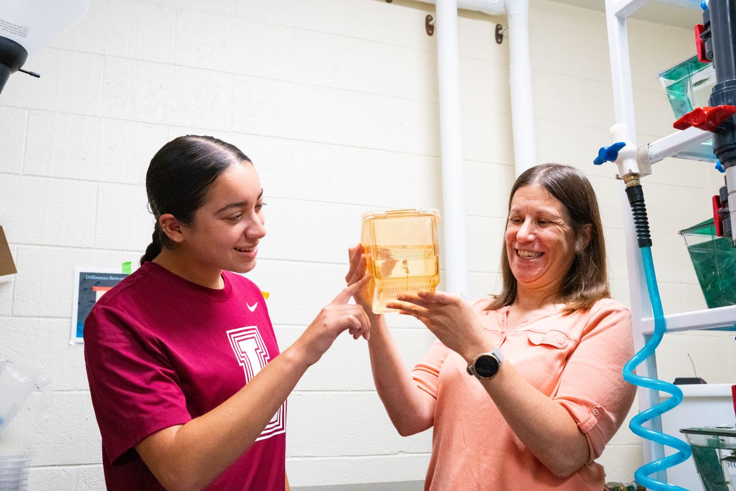 Alex Rodriguez ’28 and Tamara Stawicki, associate professor of neuroscience, examine zebrafish in a lab