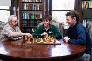 Prof. Benjamin Cohen playing chess with McKelvy co-presidents Jack Delaney and Ben Risley