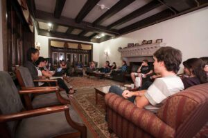 Students sit in a circle inside McKelvy House