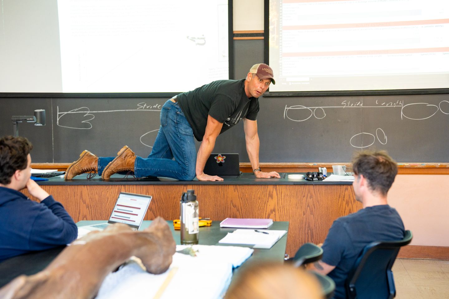 To help understand the importance of measuring stride, speed, and agility, Prof. Dave Sunderlin demonstrates how a quadruped walks. | Photo by JaQuan Alston