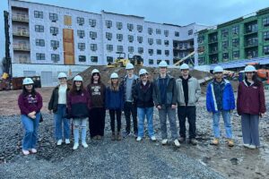 Students in Mary Wilford-Hunt's Introduction to Structural Engineering course posing in front of The Confluence during a site walk