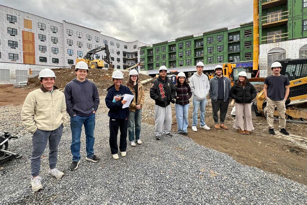 Students in Mary Wilford-Hunt's Introduction to Structural Engineering course posing in front of The Confluence during a site walk