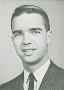 Black and white headshot of Richard Thayer. Richard is wearing a white shirt, black tie and a dark jacket.