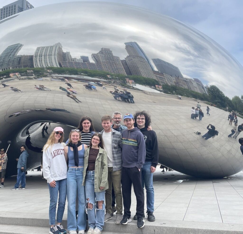A group of students with Prof. Steve Kurtz in front of Chicago's bean