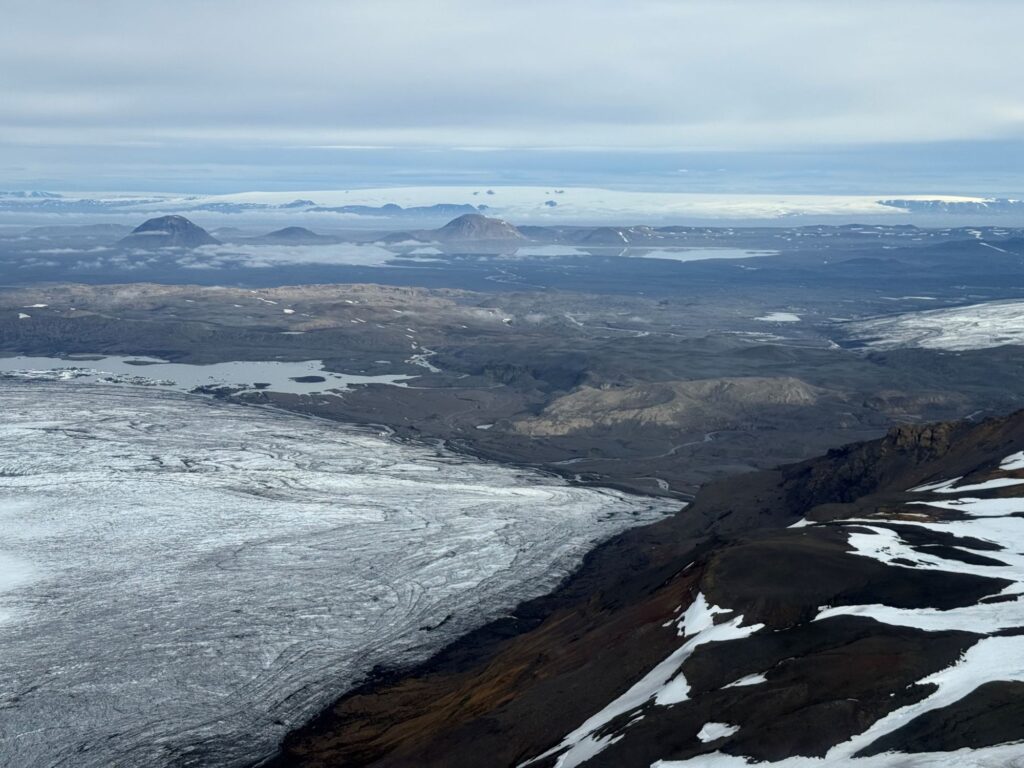 July 2025 at the western margin of Vatnajökull, about to land at a volcano named Hamarinn, looking west across to Hofsjökull, a neighboring ice cap. | Photo by Tamara Carley