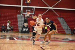 Teresa Kiewiet playing basketball for the Leopards in a game against Navy