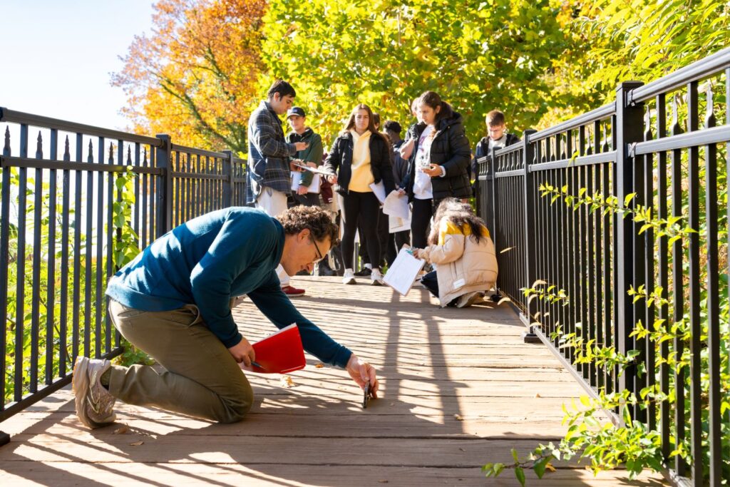 Mike McGuire and students measure a trail