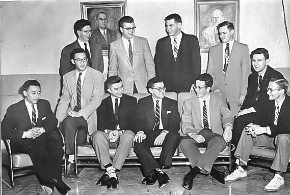 Dieu is pictured with other members of Tau Beta Pi. They are all wearing suits. Dieu is on the far left seated.