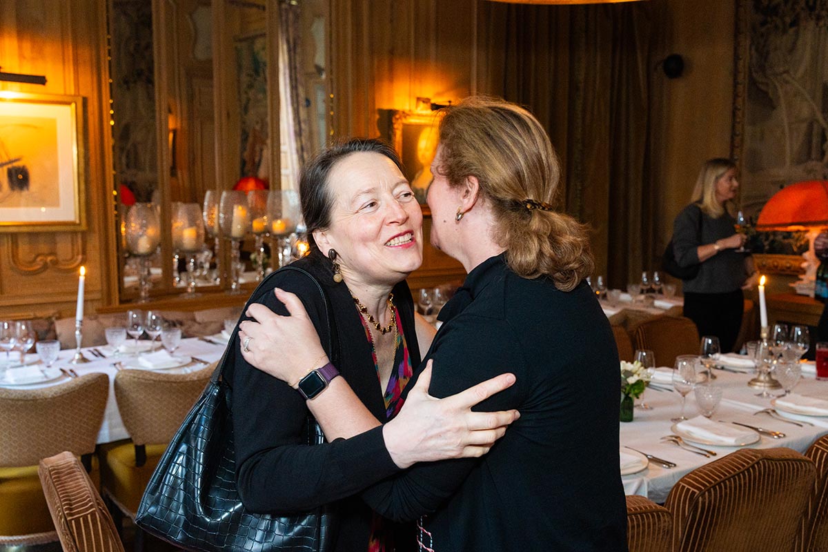 Two women greet each other