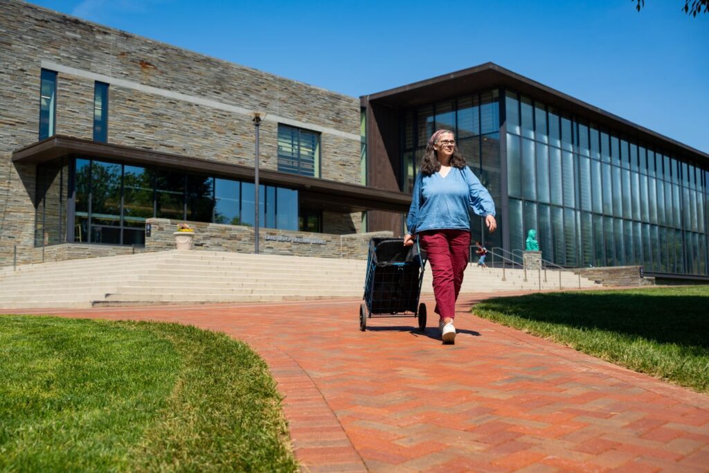 Beth Sica, archives technician, takes a cart of yearbooks across the Quad to print services. (Photo | JaQuan Alston)