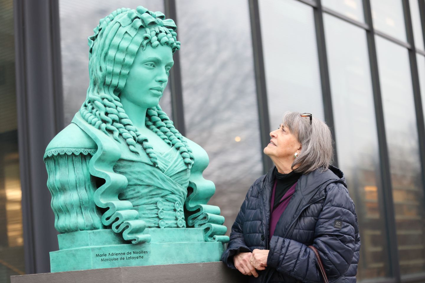 Diane Shaw, College archivist emeritus, takes a moment to admire Audrey Flack's bust of Adrienne during its March 7 dedication. | Photo by Ashli Truchon Novak