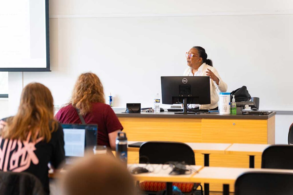 Prof. Wendy Wilson-Fall delivering a lecture to students during her AFS 330 Cowboys in Africa course