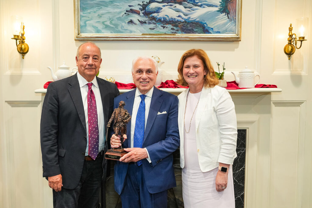 Bob and Nicole pose with Harry Cherken. Harry is holding a miniature statue of Marquis de Lafayette.