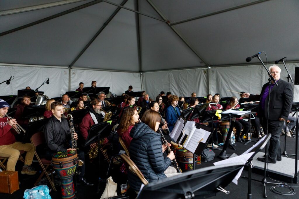 Kirk O’Riordan, associate professor of music and director of bands, leads the Commencement Band on May 23. "Commencement is all about making sure everything is working," he says. | Photo by Rick Smith