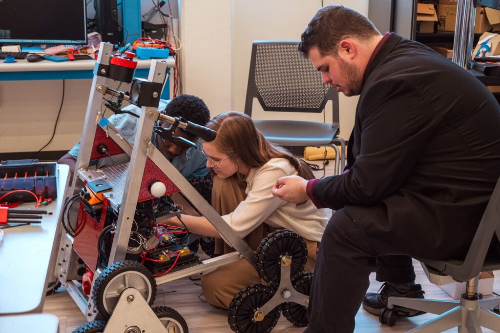 Daly Gibson ’26 and Sam Satalof ’26 fine tune the smart walking assistive device moments before revealing its capabilities. | Contributed photo