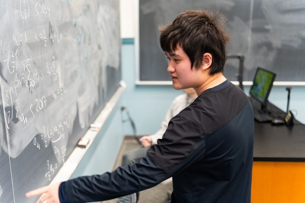 A successful Putnam competitor, Trung Nguyen ’29 works on a math problem for the sheer joy of it. | Photo by JaQuan Alston