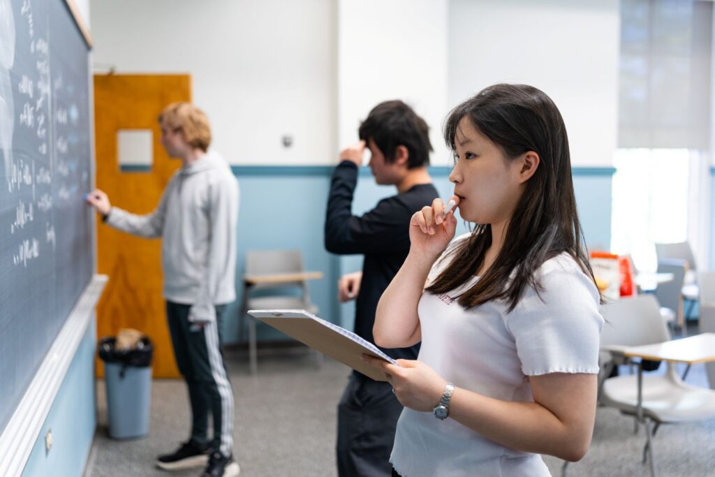 Wonhee Choi ’29 ponders a math problem. | Photo by JaQuan Alston