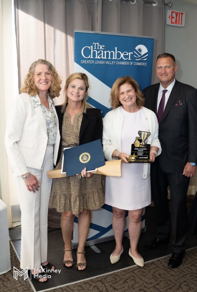 Pictured from left to right Vicki Doulé, Audra Kahr, President Nicole Hurd, and Pete Ruggiero stand in front of a LV CHamber sign. President Hurd holds the Pride of Easton award.