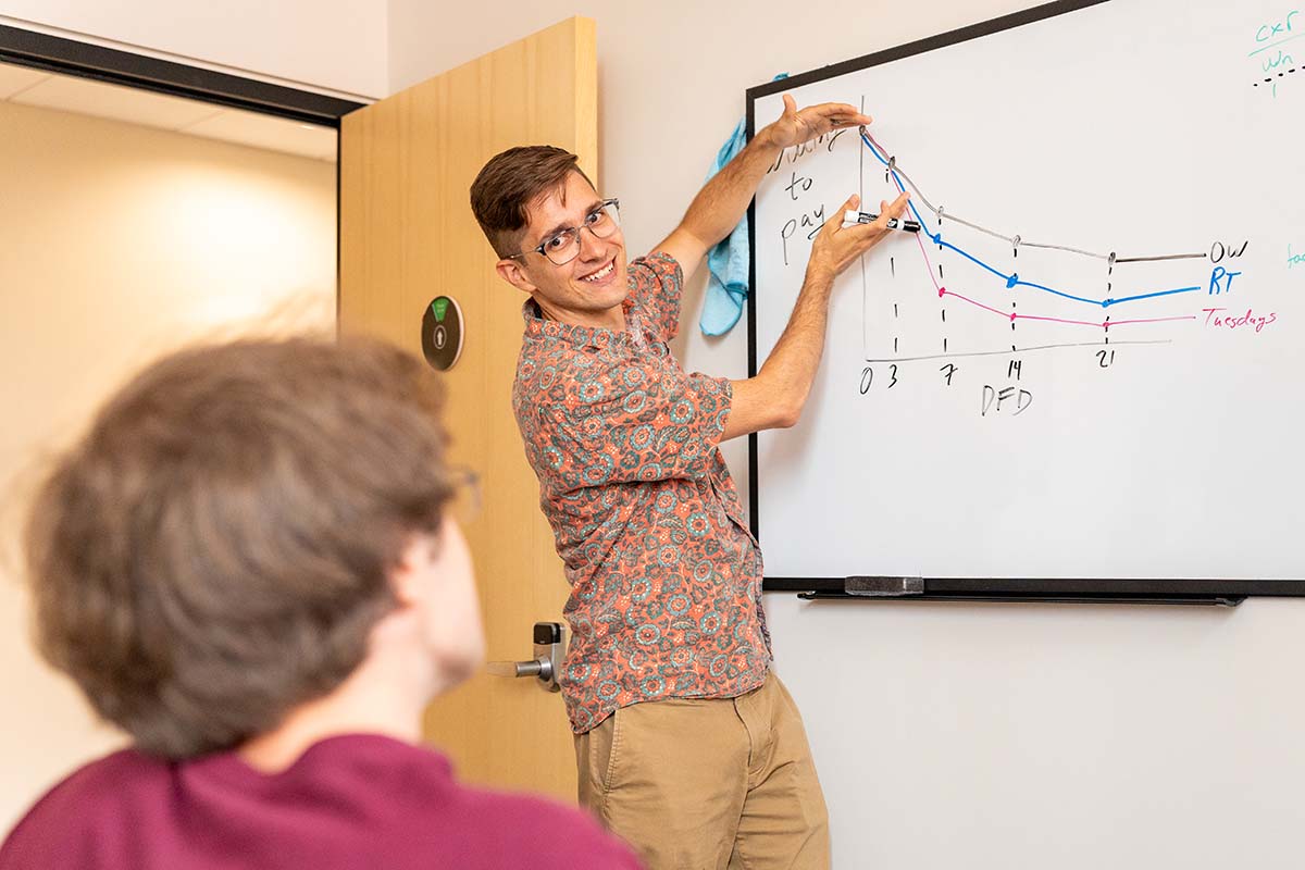 Michael Carter indicates to a whiteboard