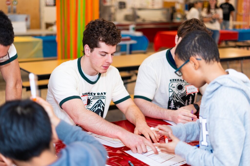 Lafayette students sit at a table with EASD students as they work on an activity during the annual Literacy Day