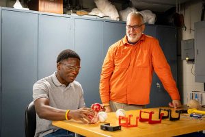 Tendai Ankude '28 and Prof. Tobias Rossmann conducting research on cricket balls in the lab