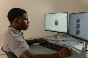 Tendai Ankude '28 using a data collection system to analyze the lift force, drag force, angle of attack, and rotations per minute of a cricket ball