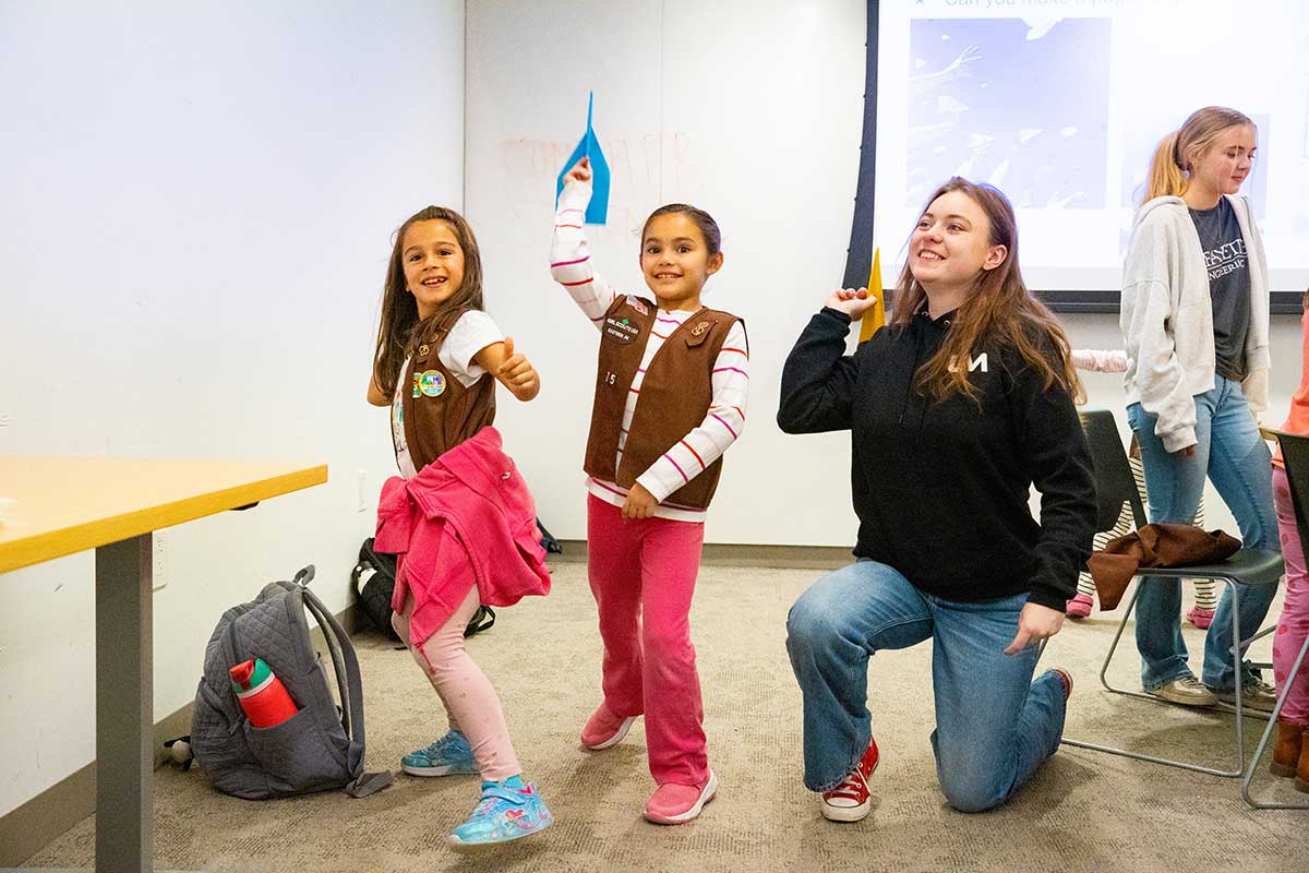 Two Girl Scout Brownies test their fling fliers with a Lafayette engineering student during Girl Scout Badge Day.