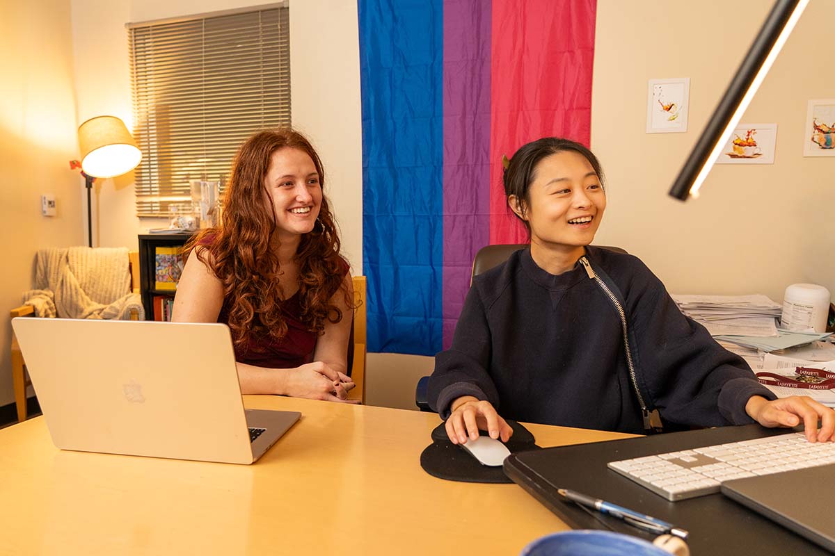 Chu Chu and Julia Mudry sit at a desk looking at a computer