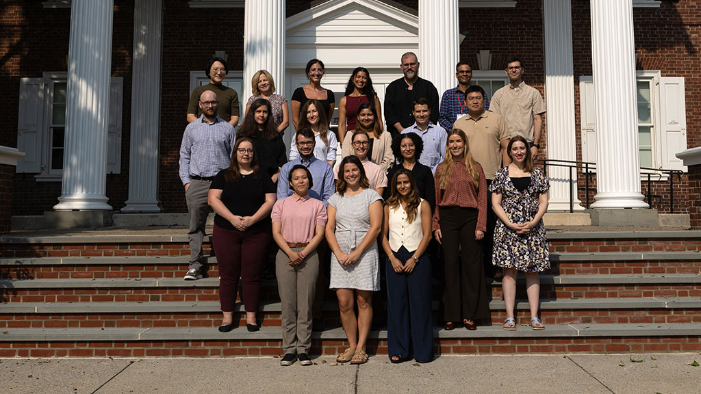 Faculty members stand in front of Ramer History house
