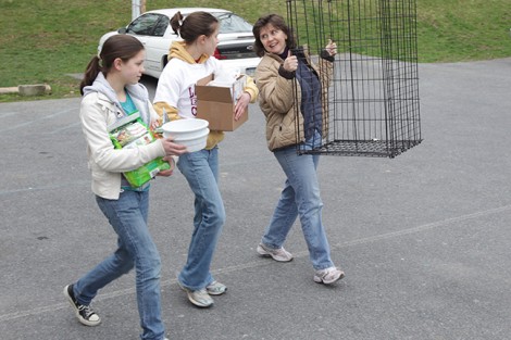Becky Rosenbauer '84, right, and her daughters, Laura, 15, and Annie, 18, carry supplies. 